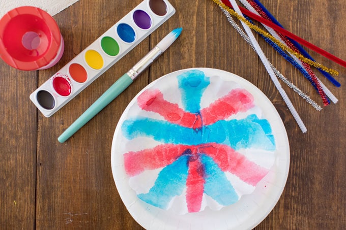 painted coffee filter on a paper plate