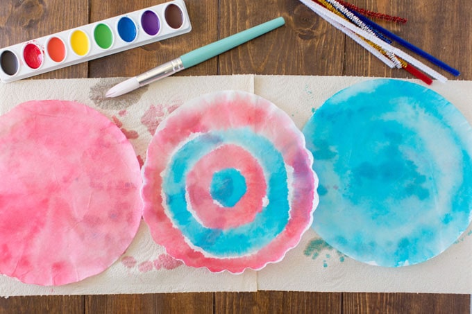 three painted coffee filters on paper towels