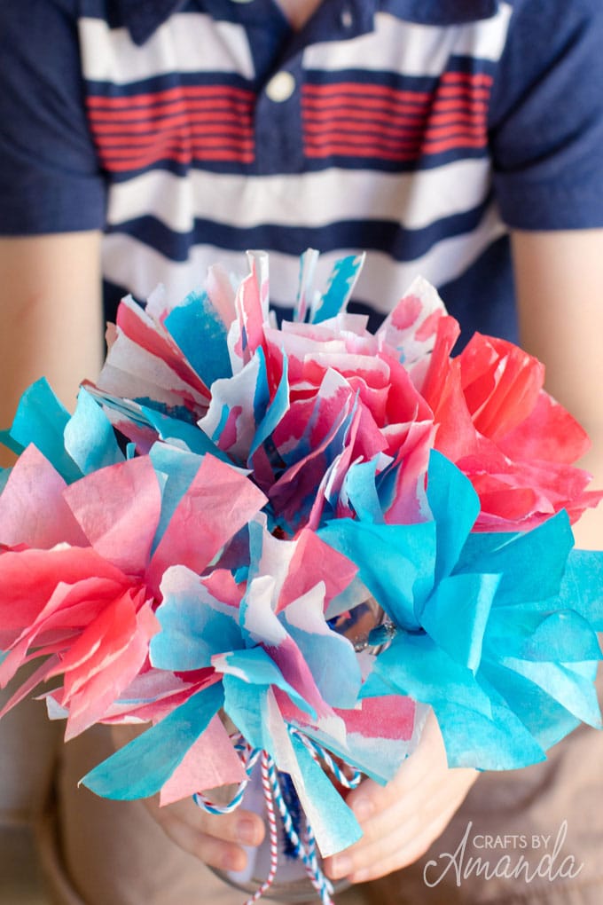 boy holding bouquet of coffee filter flowers