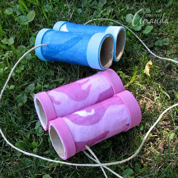 Binoculars made from cardboard tubes and felt laying in the grass