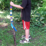 boy holding a walking stick