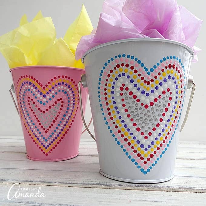 Valentine's Day is coming soon, so you're going to need something fun to give out goodies in! These Valentine treat buckets adorned in polka dotted hearts make for a great gift filled with chocolate or other candies.