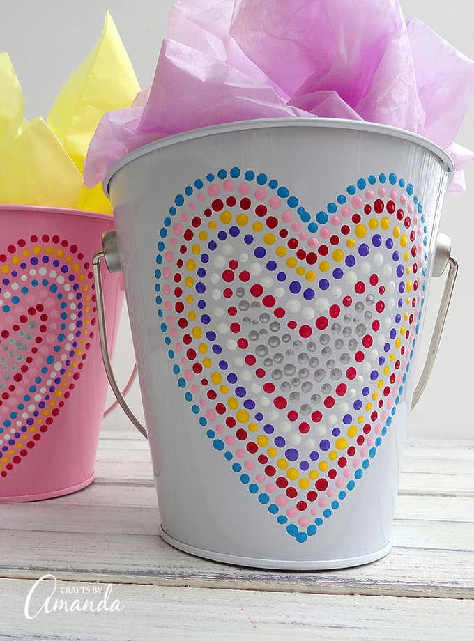 Valentine's Day is coming soon, so you're going to need something fun to give out goodies in! These Valentine treat buckets adorned in polka dotted hearts make for a great gift filled with chocolate or other candies.