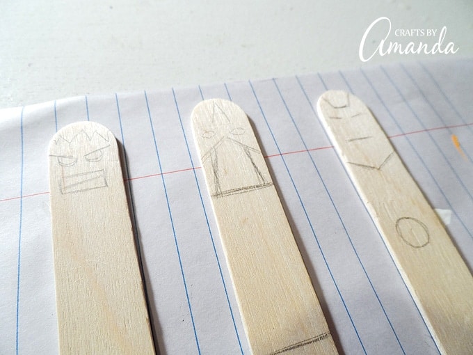 craft sticks with avenger faces drawn on
