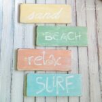 These DIY beach signs are a gorgeous addition to your coastal decor. Make these beach signs yourself with these simple instructions.