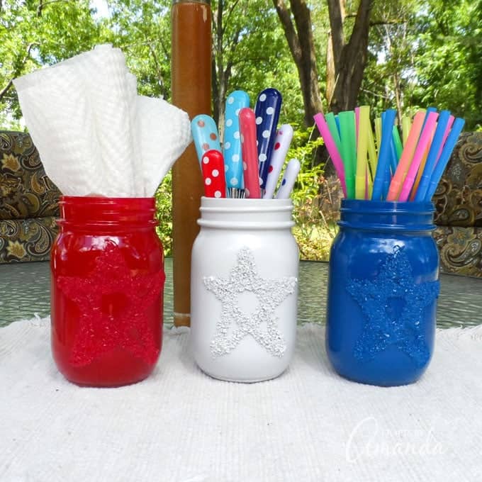 mason jars painted in red white and blue used as utensil holders