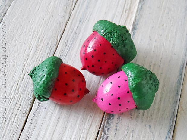 Acorns painted like strawberries in pink and red