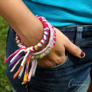 These colorful t-shirt bracelets are an easy to make recycled craft project and are perfect for teenagers or preteens! All you need are inexpensive bangle bracelets and some old t-shirts to make these pretty fashion statements.