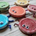 Cute Glitter Bugs made from recycled jar lids! Great for Earth Day! From CraftsbyAmanda.com