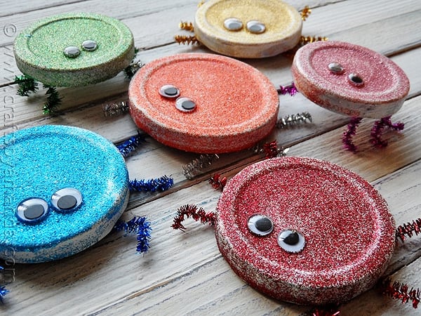 Cute Glitter Bugs made from recycled jar lids! Great for Earth Day! From CraftsbyAmanda.com