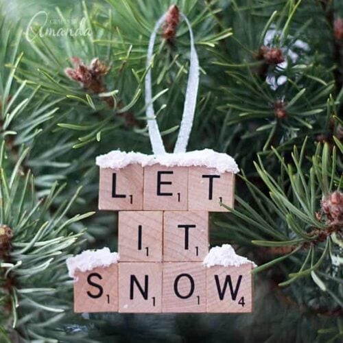 Make a "Let It Snow" scrabble tile ornament from scrabble tiles and snow texture paint! So easy to make, you will need a paper plate and some felt too, great to give as gifts! A fun Christmas ornament project for kids and adults.