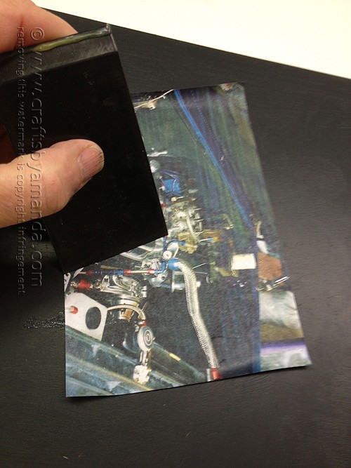 Using a decoupage squeegee to apply photo 