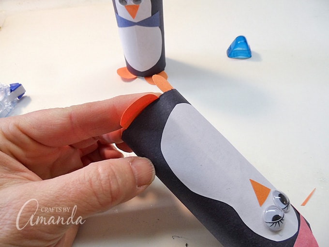 gluing feet to cardboard penguin