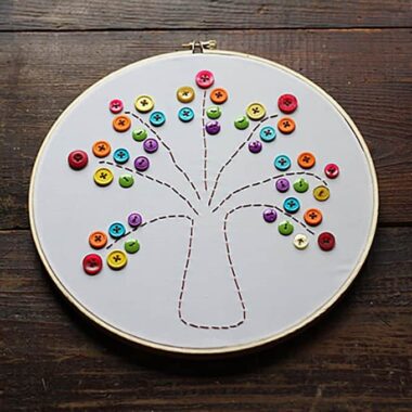 This embroidery hoop rainbow tree is a great project for beginners, and easy enough for kids. This rainbow tree makes a colorful and happy piece of art! #embroidery #kidscrafts #sewing #needlework #stpatricksday #stpatricksdaycrafts #adultcrafts #beginnersewing #embroideryhoop