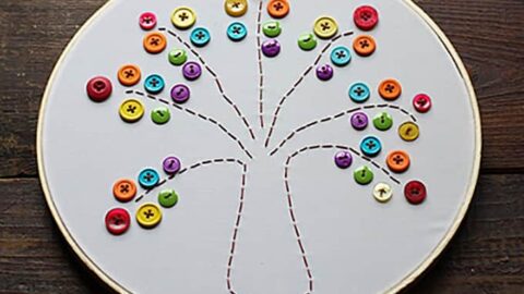 This embroidery hoop rainbow tree is a great project for beginners, and easy enough for kids. This rainbow tree makes a colorful and happy piece of art! #embroidery #kidscrafts #sewing #needlework #stpatricksday #stpatricksdaycrafts #adultcrafts #beginnersewing #embroideryhoop