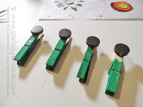 Glue a magnet to each clothespin