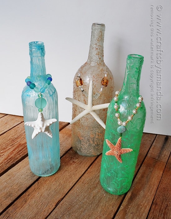 Wine bottle crafts are really popular right now, and it's summertime, so beach crafts are a hit too. I'll show you how to make these beachy wine bottles!