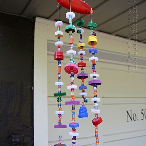 Make a wind chime from recycled plastic lids! Full step by step tutorial with printable instructions from Crafts by Amanda!