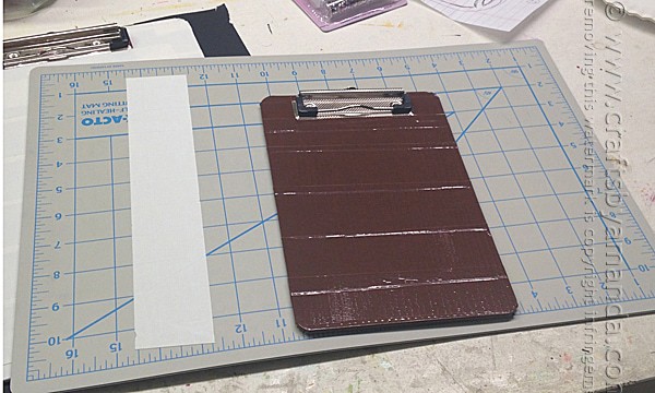 Cover the clipboard in brown duct tape