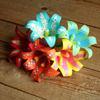 five paper flowers with a tropical theme bunched together