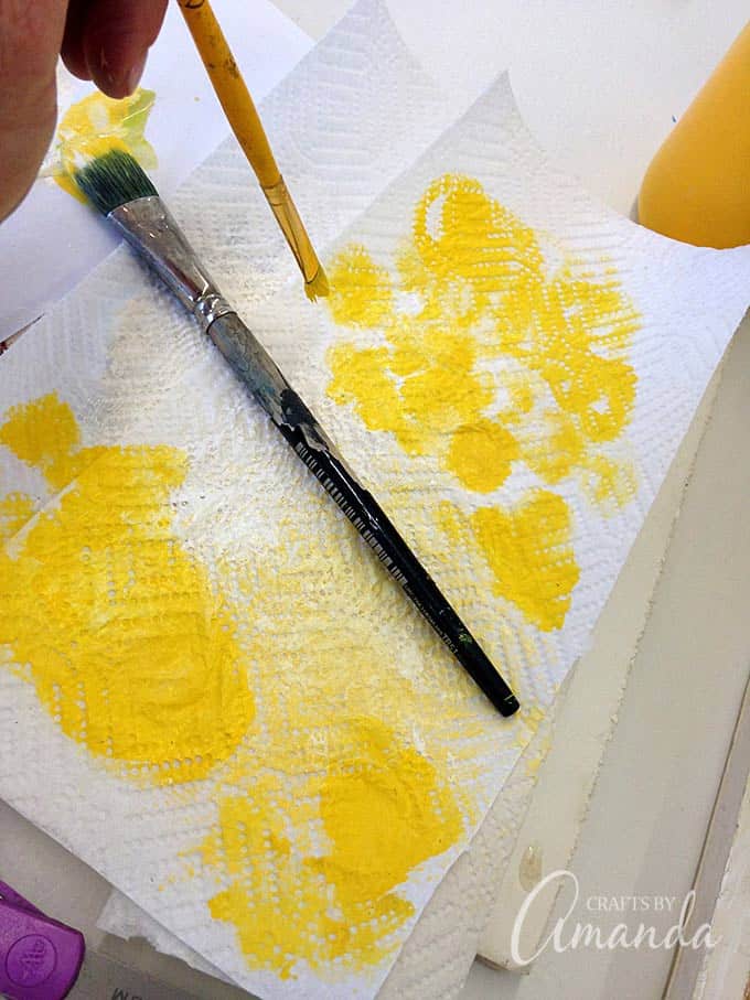 yellow paint on paint brush