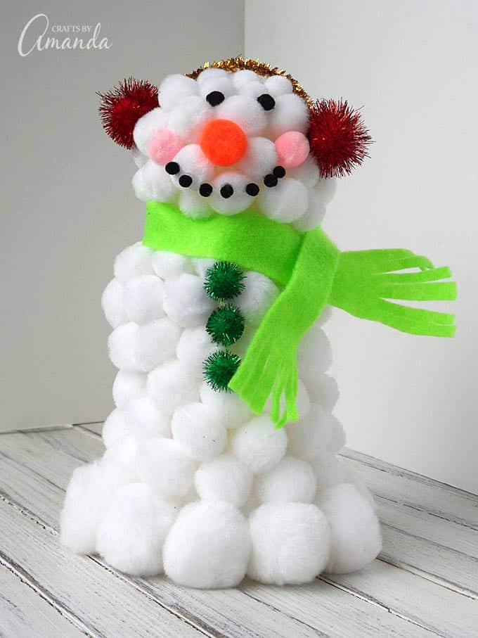 This fluffy pom pom snowman is a fun winter craft for kids. It's easy to make and uses craft supplies you likely have around the house already.