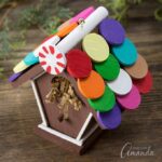 Just in time for the holidays, learn how to make a colorful wooden Gingerbread Birdhouse Ornament from a miniature craft birdhouse, wooden circles, and acrylic paint.