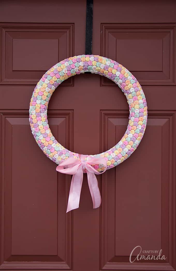 Conversation heart wreath hanging on door