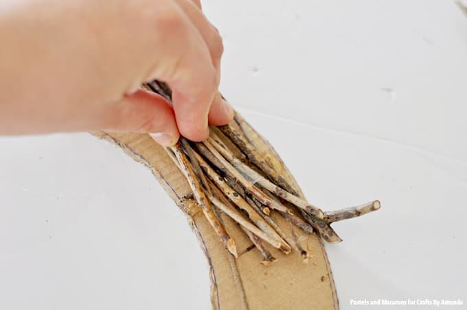 Use hot glue to add twigs to wreath form