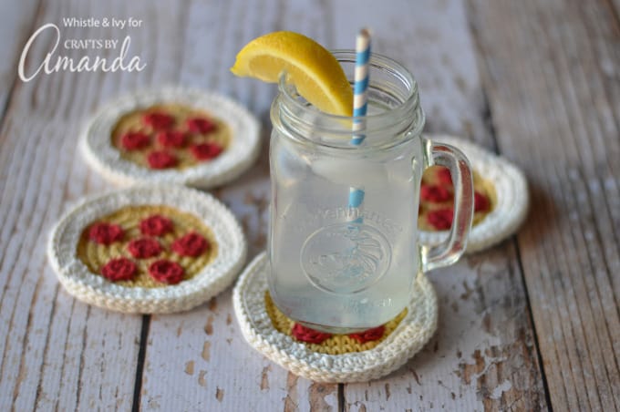 Glass of water on top of crochet pizza coasters