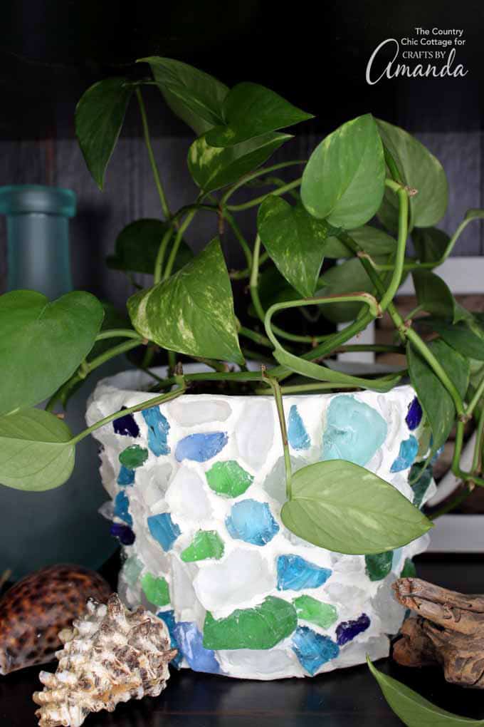 Planter with sea glass and clay with plant inside