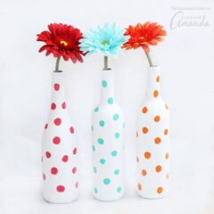 These Polka Dot Wine Bottle Vases are the perfect wine bottle craft! Pair with brightly-colored flowers to add a bit of cheer to any room in your house.