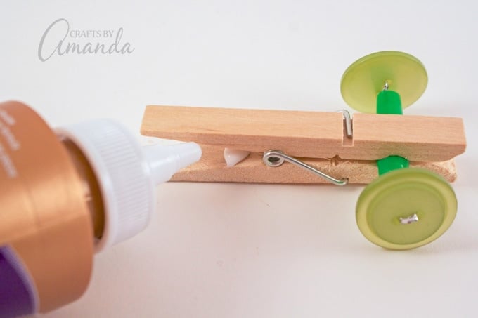 Add a dab of white glue to the back of the clothespin near the spring.