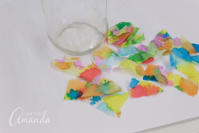 Tear painted coffee filter into pieces. The size is up to you, it just makes them easier to attach to the surface of the jar. Smaller pieces (about 2-inches) mean less wrinkles.