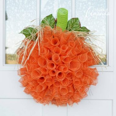 Make this wonderful deco mesh pumpkin wreath to hang on your door this fall!