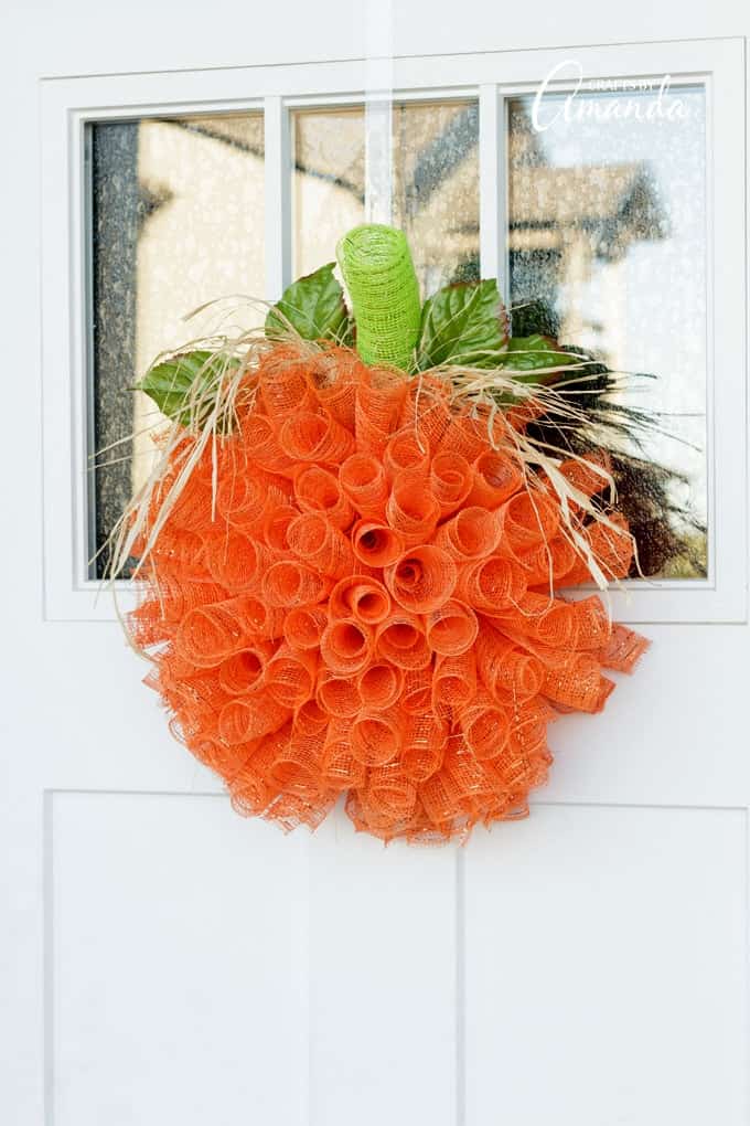 Deco mesh pumpkin wreath on door