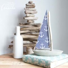 While you won't want to try floating it, this DIY concrete and driftwood sailboat is a breezy nautical or coastal decor idea for your home or cottage.