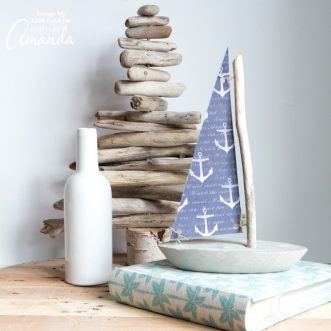 While you won't want to try floating it, this DIY concrete and driftwood sailboat is a breezy nautical or coastal decor idea for your home or cottage.
