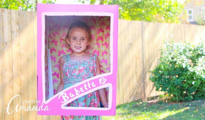 little girl in a pink painted box