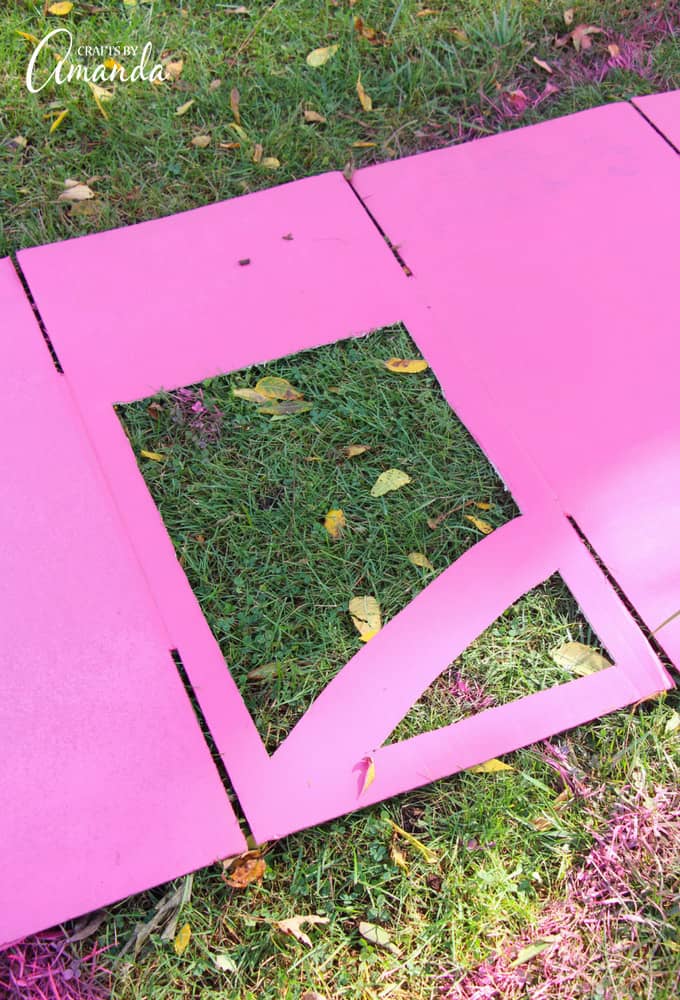 cutting out a window on a pink box