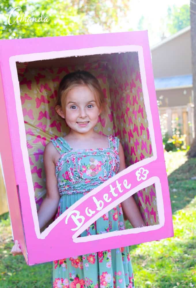 little girl as a doll in a box