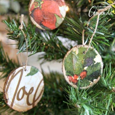 These decoupage wood slice ornaments are an easy way to make your own tree ornaments. Use paper napkins in any pattern or color to make custom ornaments.