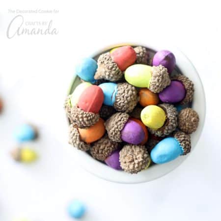 These painted acorns are an easy seasonal craft. Gathered in little bowls or spread on your table these acorns make a colorful Thanksgiving centerpiece!
