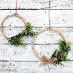 Learn how to make a simple winter greenery embroidery hoop wreath. This easy to make wreath is perfect for decorating throughout the winter.
