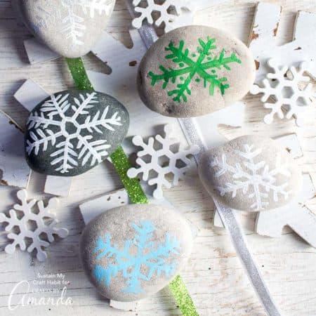 Add a fun little accent to your holiday decor with these painted rock snowflakes. Grab the template for this simple and relaxing rock painting craft.
