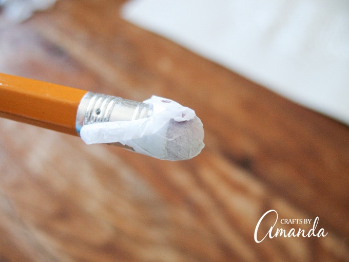 Wrap the square around the end of a pencil’s eraser then place the eraser with the tissue paper onto the glue. 