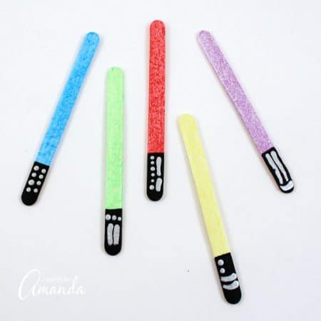 Keep your place in your favorite books by making glittery lightsabers in different colors! These lightsaber bookmarks are great for home or school.
