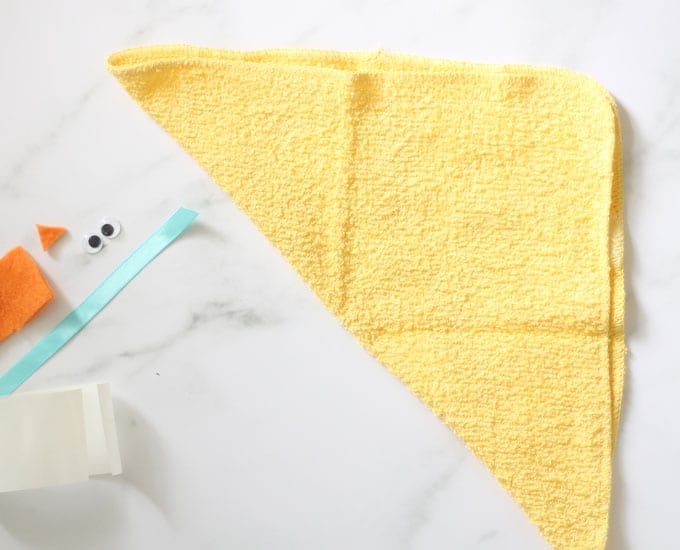 yellow washcloth folded into triangle