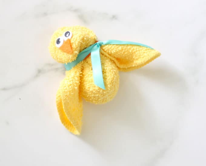 yellow chick washcloth with googly eyes and ribbon