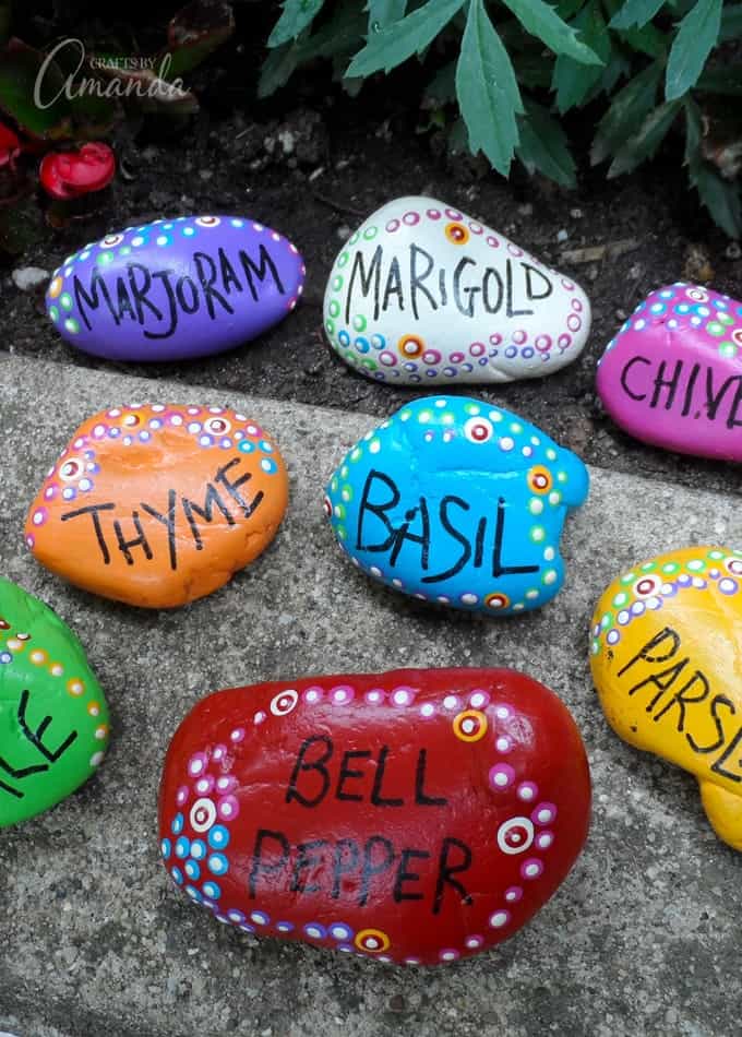 Pretty painted rock garden markers for your herb, flower, or veggie garden.